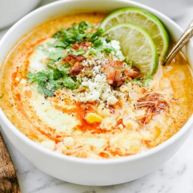 Bowl of Slow Cooker Mexican Street Corn Soup topped with cilantro and lime