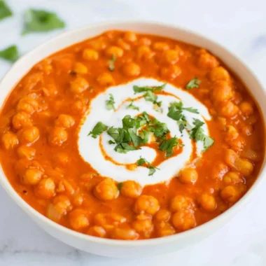 Delicious vegan chickpea curry served in a bowl with spices and herbs.