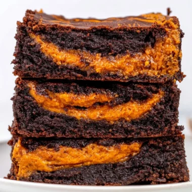 Delicious homemade pumpkin brownies topped with chocolate drizzle
