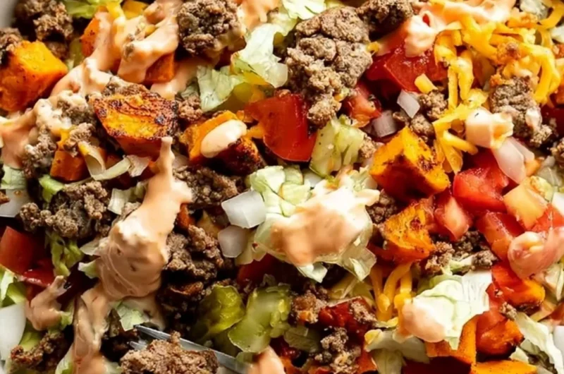 Sweet Potato Burger Bowl topped with fresh vegetables and sauce