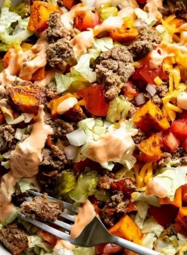 Healthy sweet potato burger bowl with vibrant vegetables and toppings